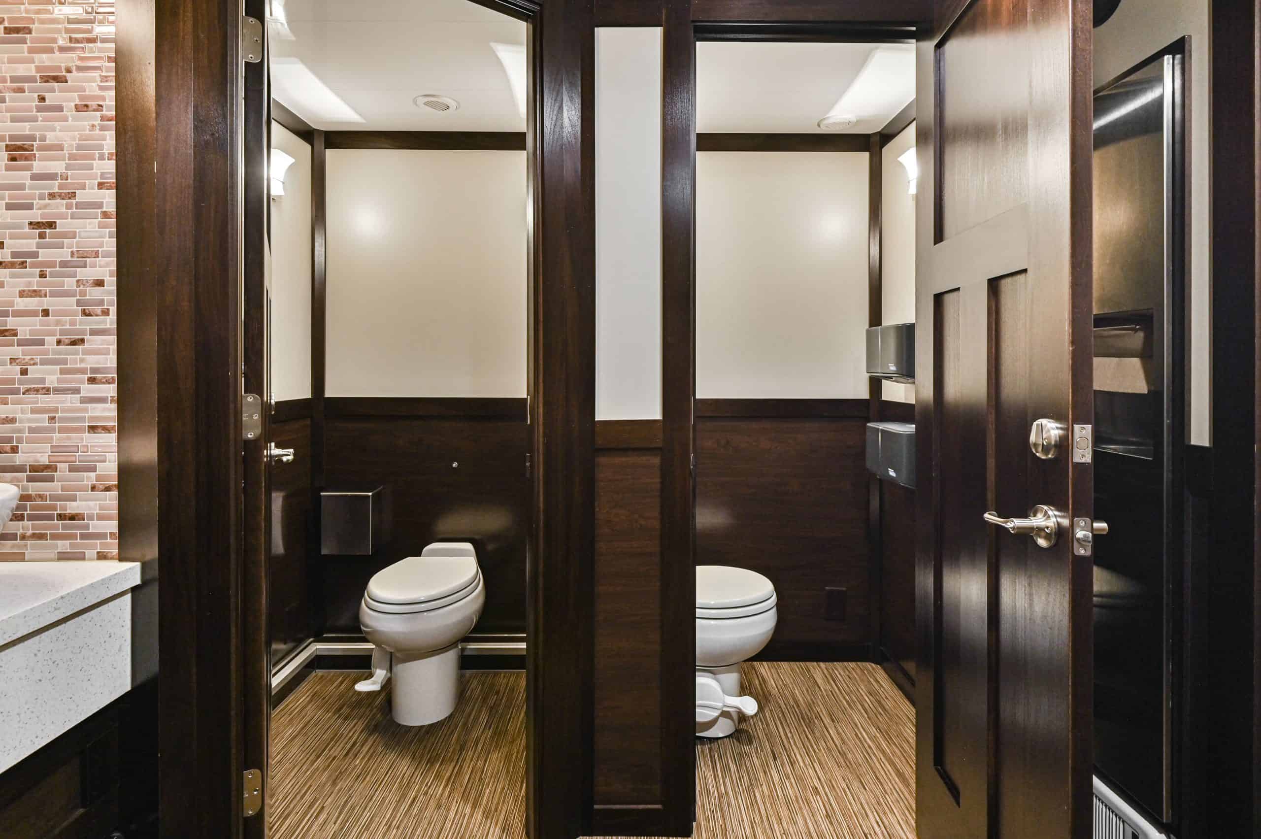 Luxury restroom trailer with elegant exterior set up at an outdoor event venue in Canada